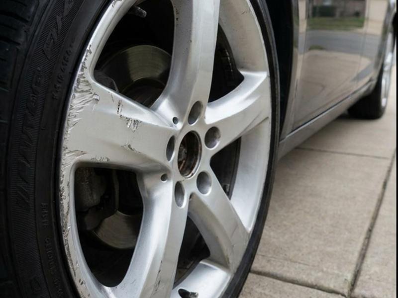 Kerb-damaged alloy wheel before refurbishment